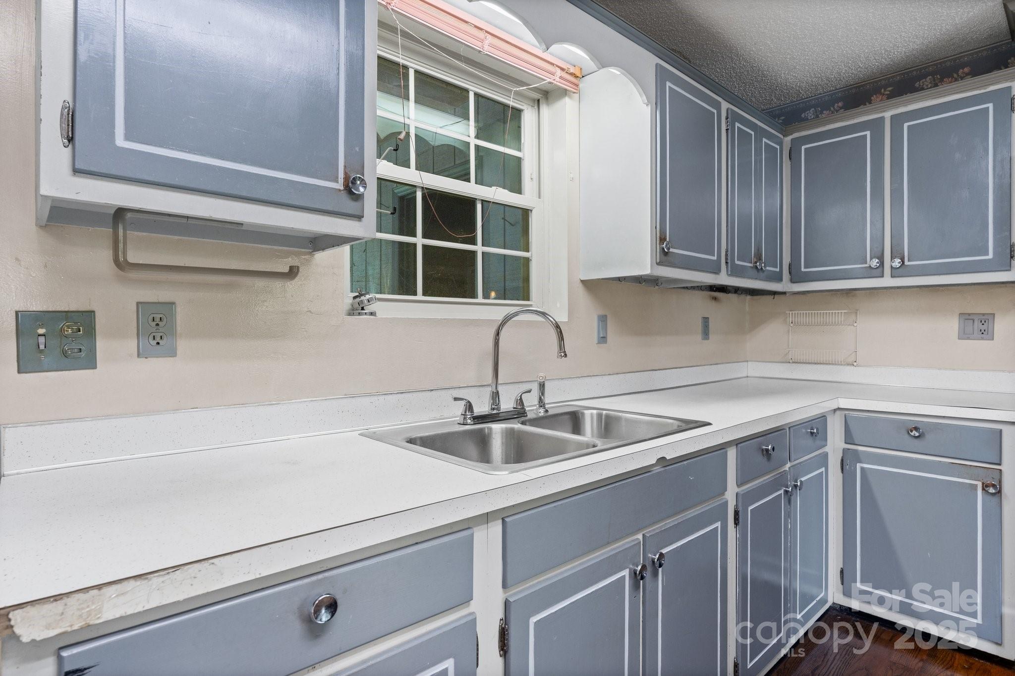 4067 Old Buff Road Hickory, NC 28602 - Photo 19 of 45 a kitchen with a sink and cabinets
