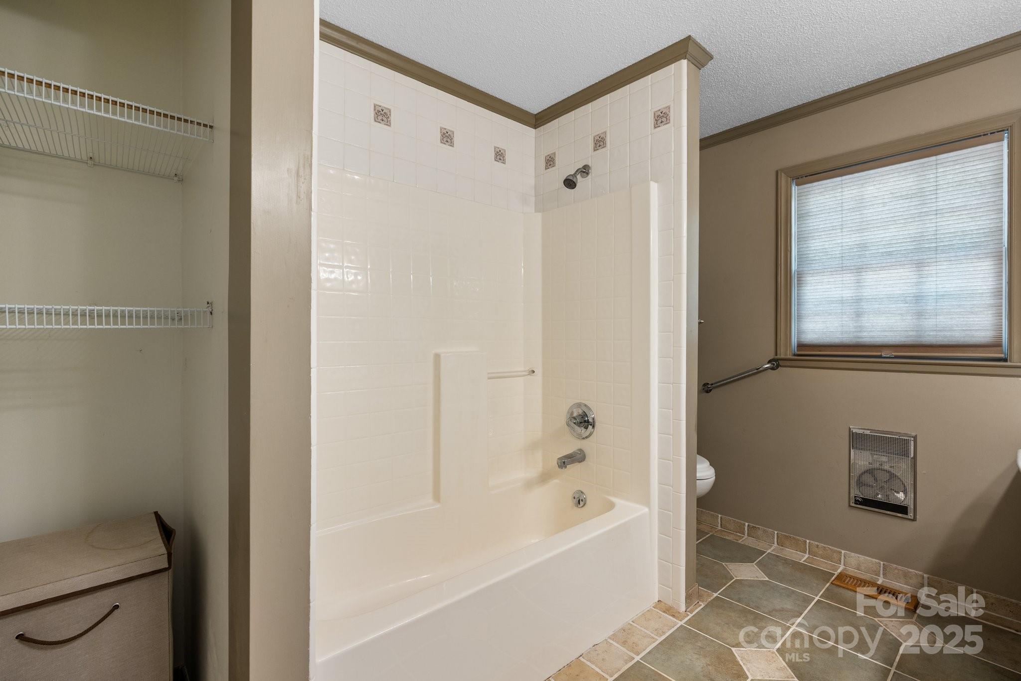 4067 Old Buff Road Hickory, NC 28602 - Photo 24 of 45 a bathroom with a bathtub a toilet and a shower