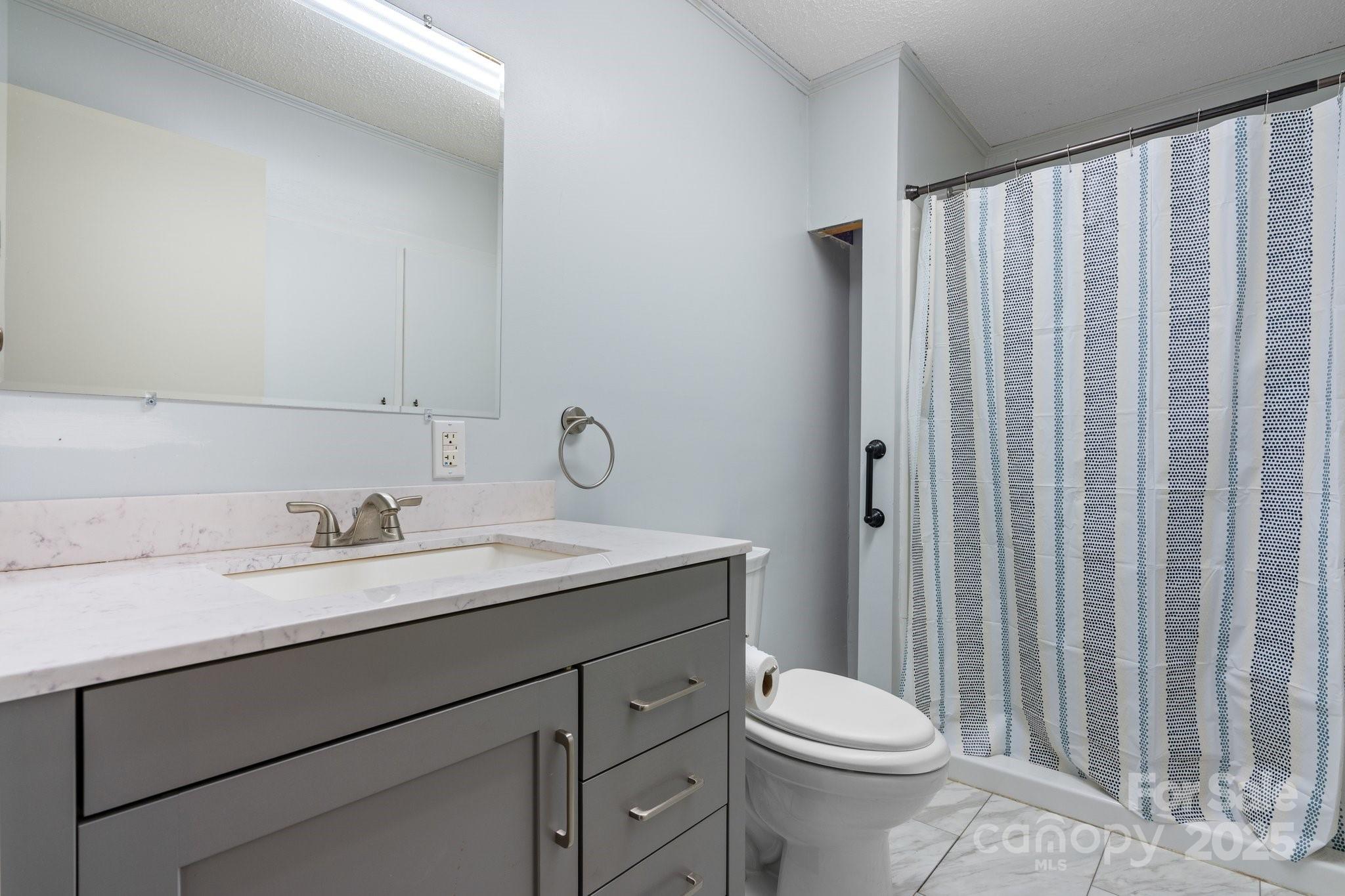 4067 Old Buff Road Hickory, NC 28602 - Photo 27 of 45 a bathroom with a sink a toilet and shower