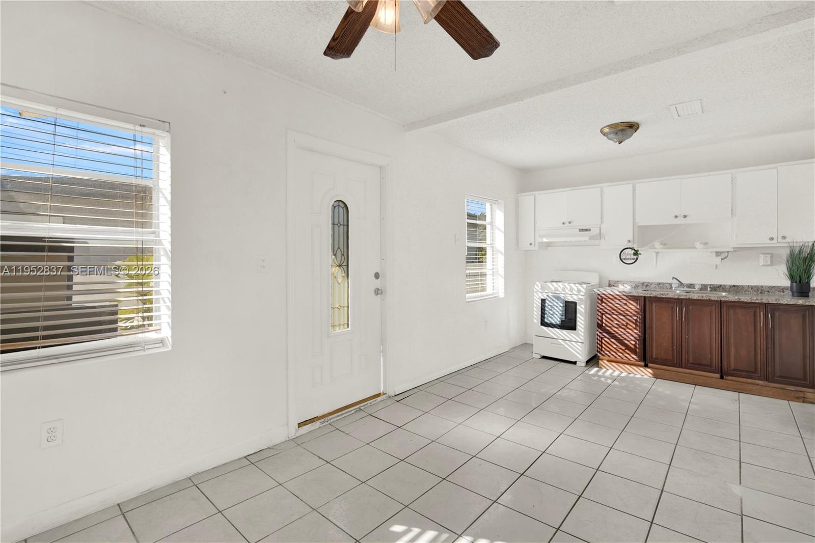 474 East 10th Street Hialeah, FL 33010 - Photo 16 of 38 a large white kitchen with cabinets
