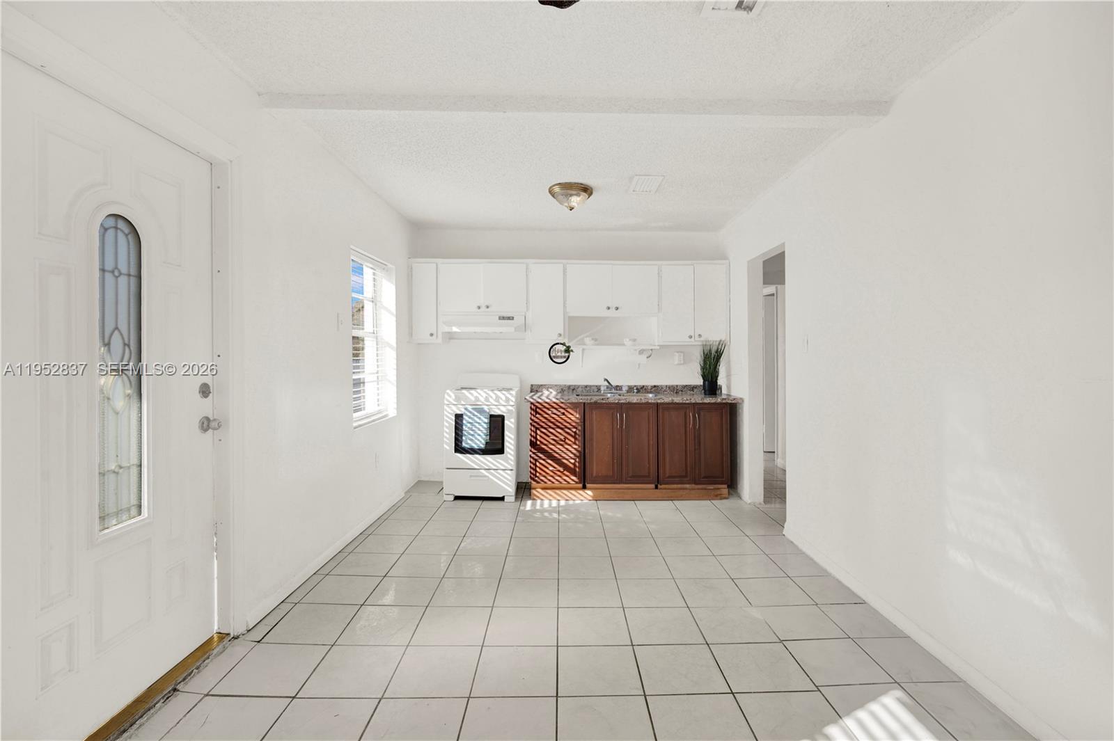 474 East 10th Street Hialeah, FL 33010 - Photo 17 of 38 a large kitchen with a stove a refrigerator and a sink