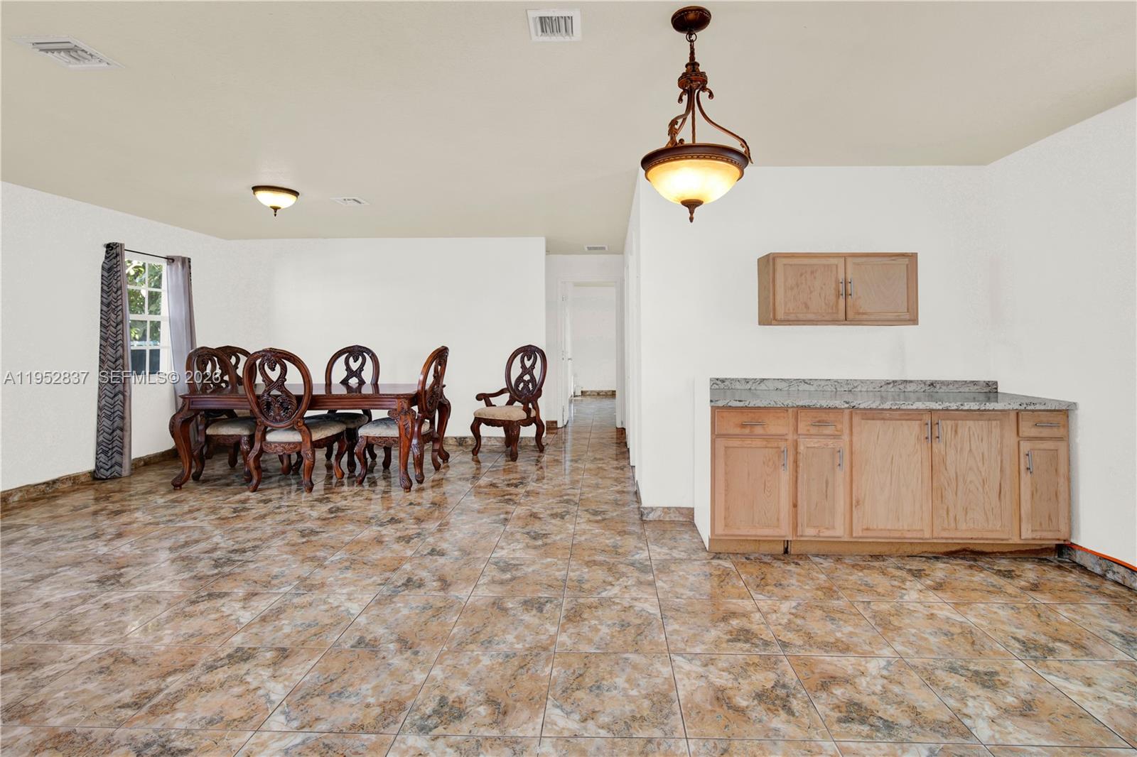 474 East 10th Street Hialeah, FL 33010 - Photo 19 of 38 a view of a room with gym equipment and a chandelier