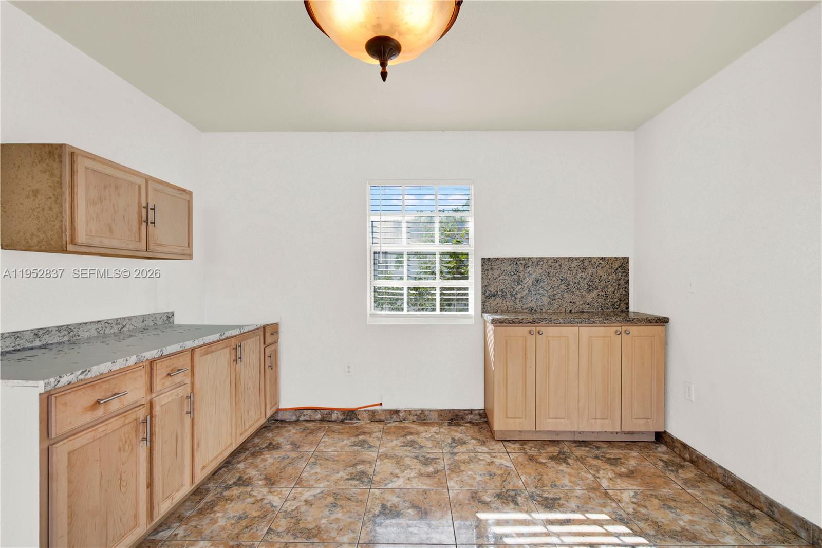 474 East 10th Street Hialeah, FL 33010 - Photo 20 of 38 a kitchen with granite countertop cabinets and window