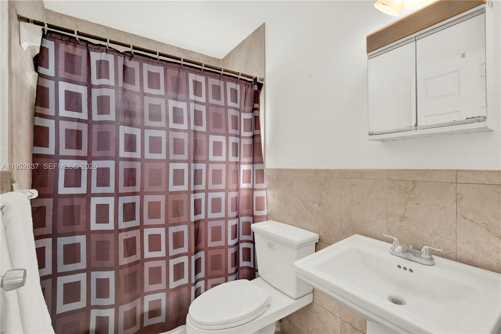 474 East 10th Street Hialeah, FL 33010 - Photo 22 of 38 a bathroom with a sink toilet and shower