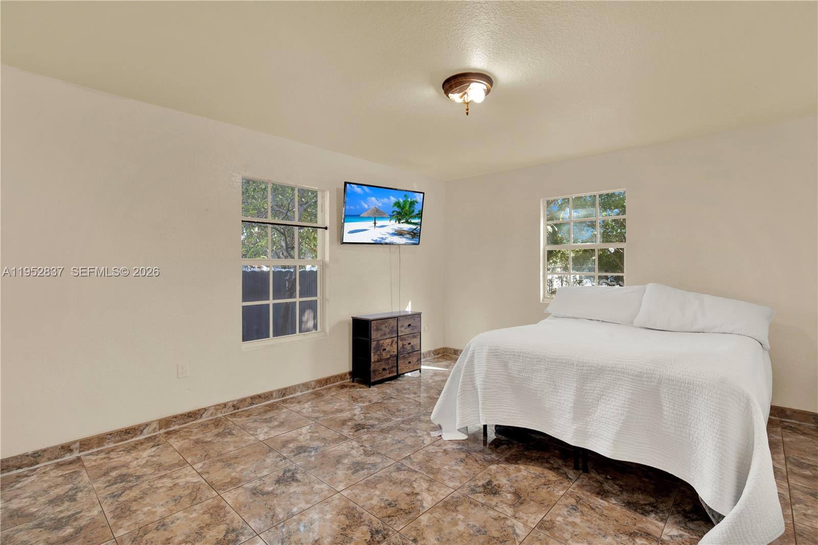 474 East 10th Street Hialeah, FL 33010 - Photo 26 of 38 a bedroom with a bed and a window