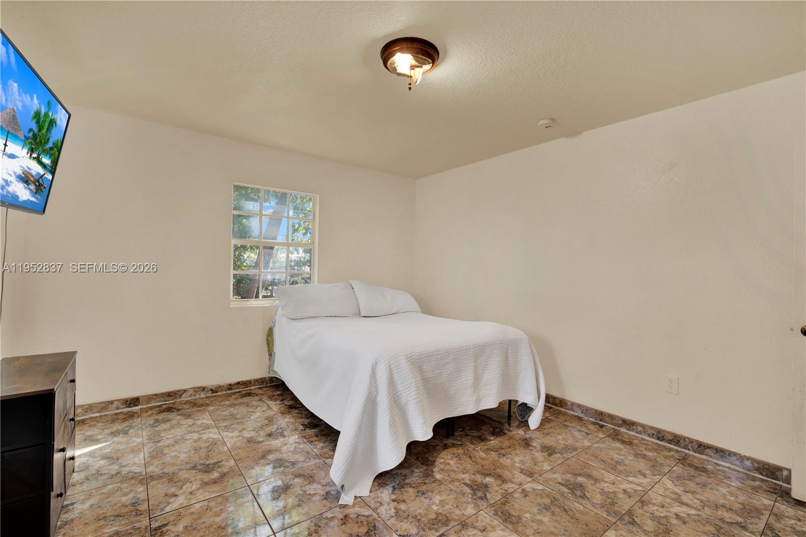 474 East 10th Street Hialeah, FL 33010 - Photo 27 of 38 a bedroom with a bed and a window