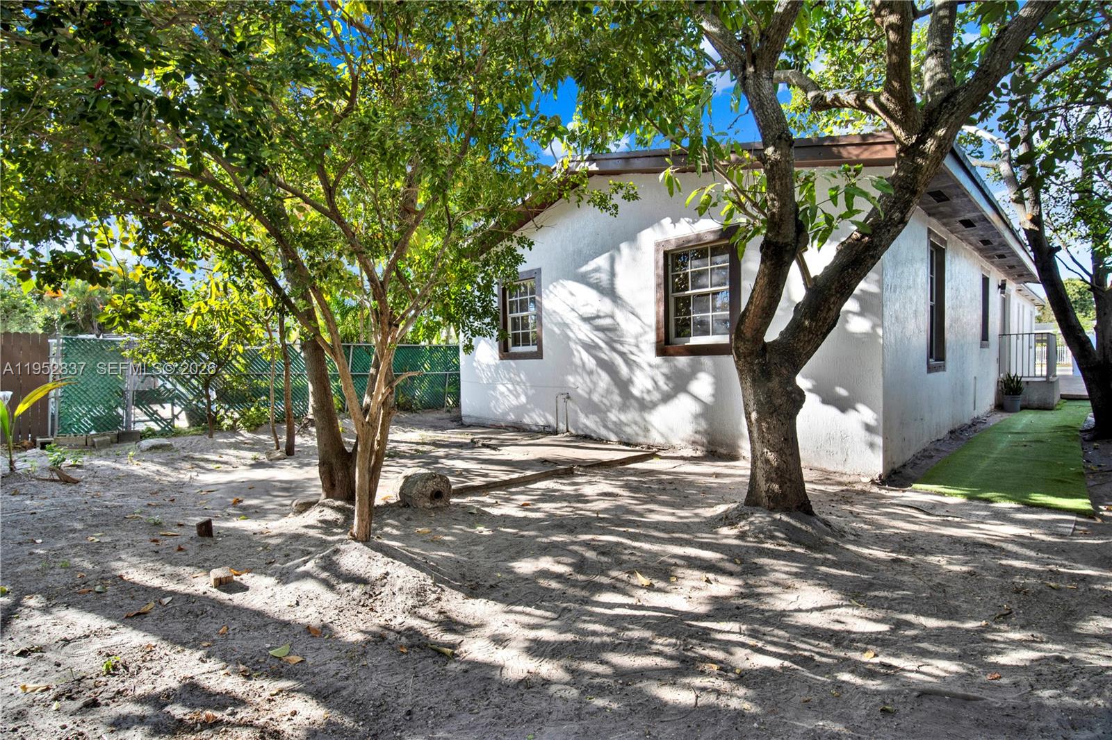 474 East 10th Street Hialeah, FL 33010 - Photo 30 of 38 a tree in the middle of a yard