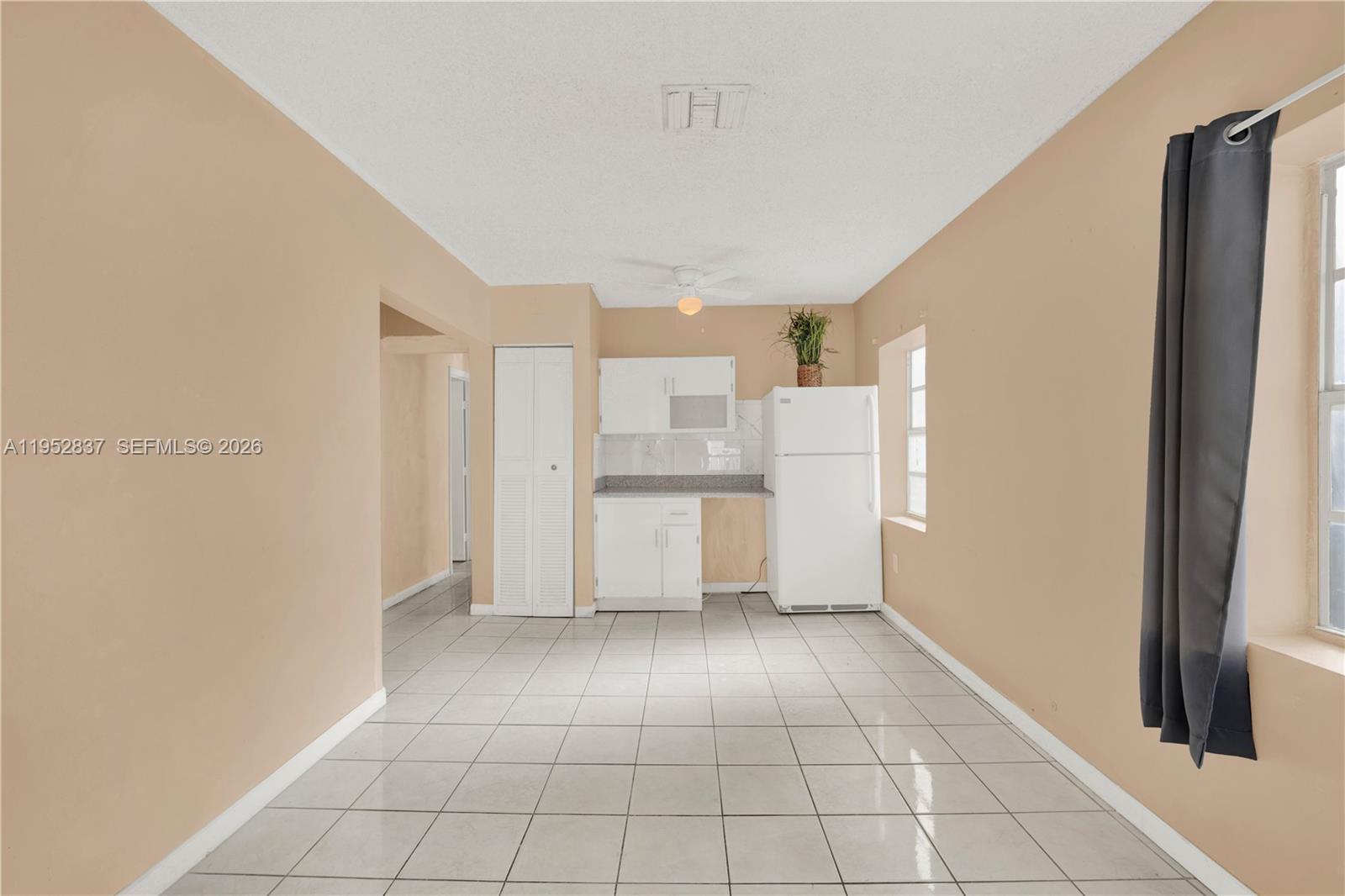 474 East 10th Street Hialeah, FL 33010 - Photo 5 of 38 a view of a kitchen with white cabinets and refrigerator