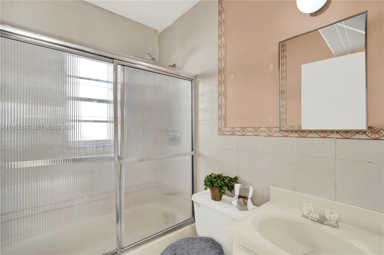 474 East 10th Street Hialeah, FL 33010 - Photo 10 of 38 a bathroom with a sink and a mirror