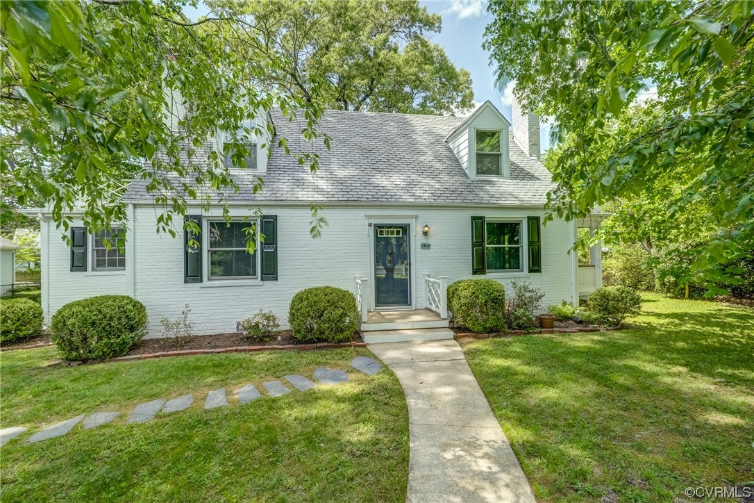 a front view of a house with a garden