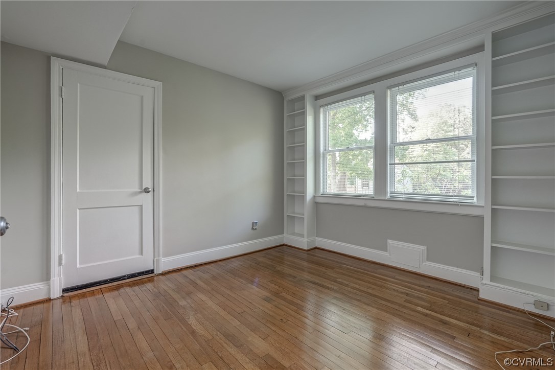1802 Bremo Road Richmond, VA 23226 - Photo 17 of 50 a view of an empty room with wooden floor and a window