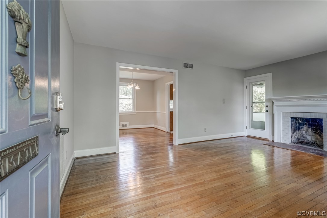 1802 Bremo Road Richmond, VA 23226 - Photo 5 of 50 a view of an empty room with wooden floor and a fireplace