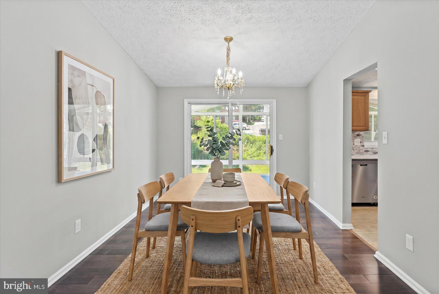 3709 Redberry Way Nottingham, MD 21236 - Photo 9 of 45 a dining room with furniture a chandelier and wooden floor