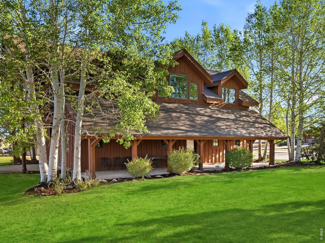 15383 East County Line Road Berthoud, CO 80513 - Photo 39 of 47 a front view of a house with a garden