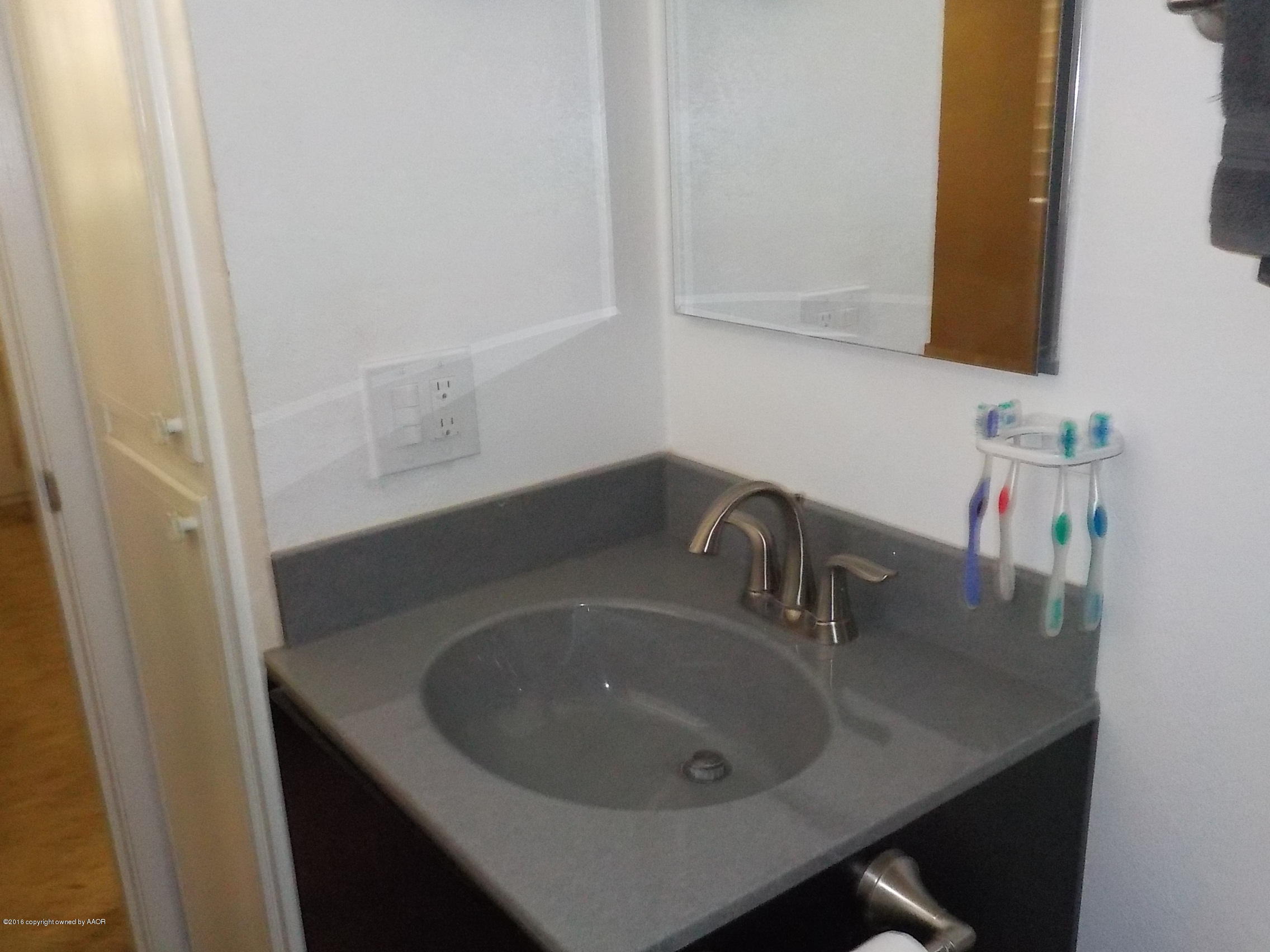 5102 Shield Drive Amarillo, TX 79110 - Photo 11 of 21 a bathroom with a sink and a mirror