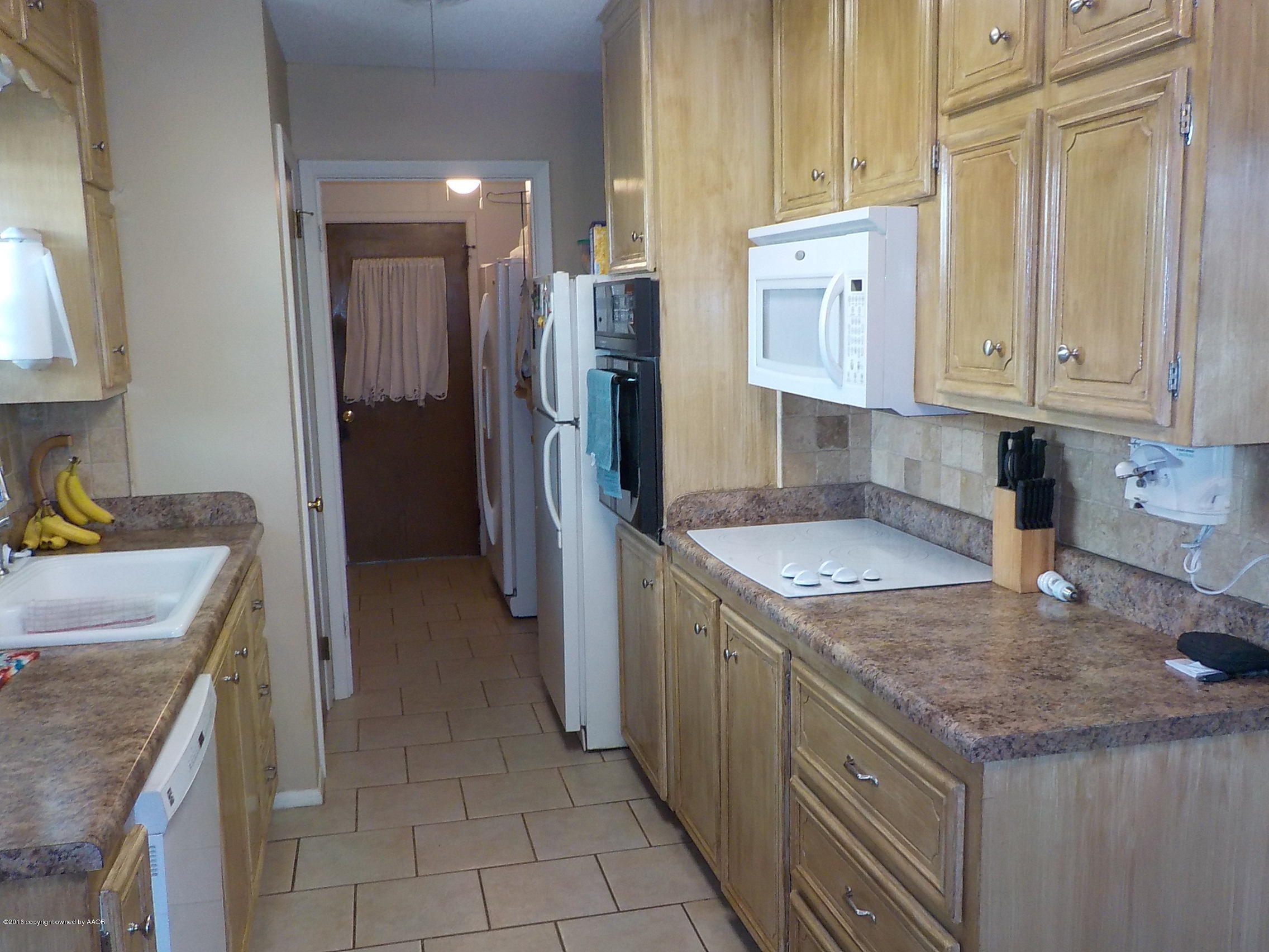 5102 Shield Drive Amarillo, TX 79110 - Photo 3 of 21 a kitchen with a sink stove and refrigerator