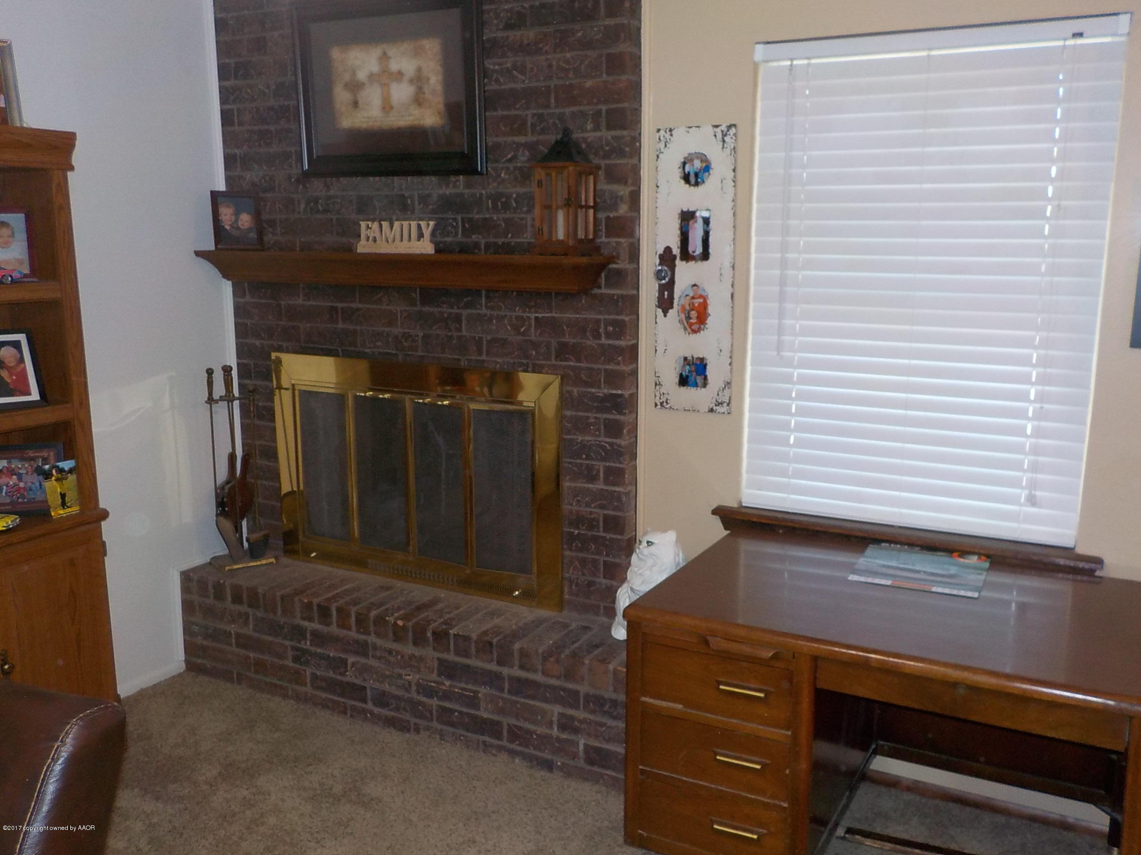 5102 Shield Drive Amarillo, TX 79110 - Photo 5 of 21 a living room with furniture and a fireplace
