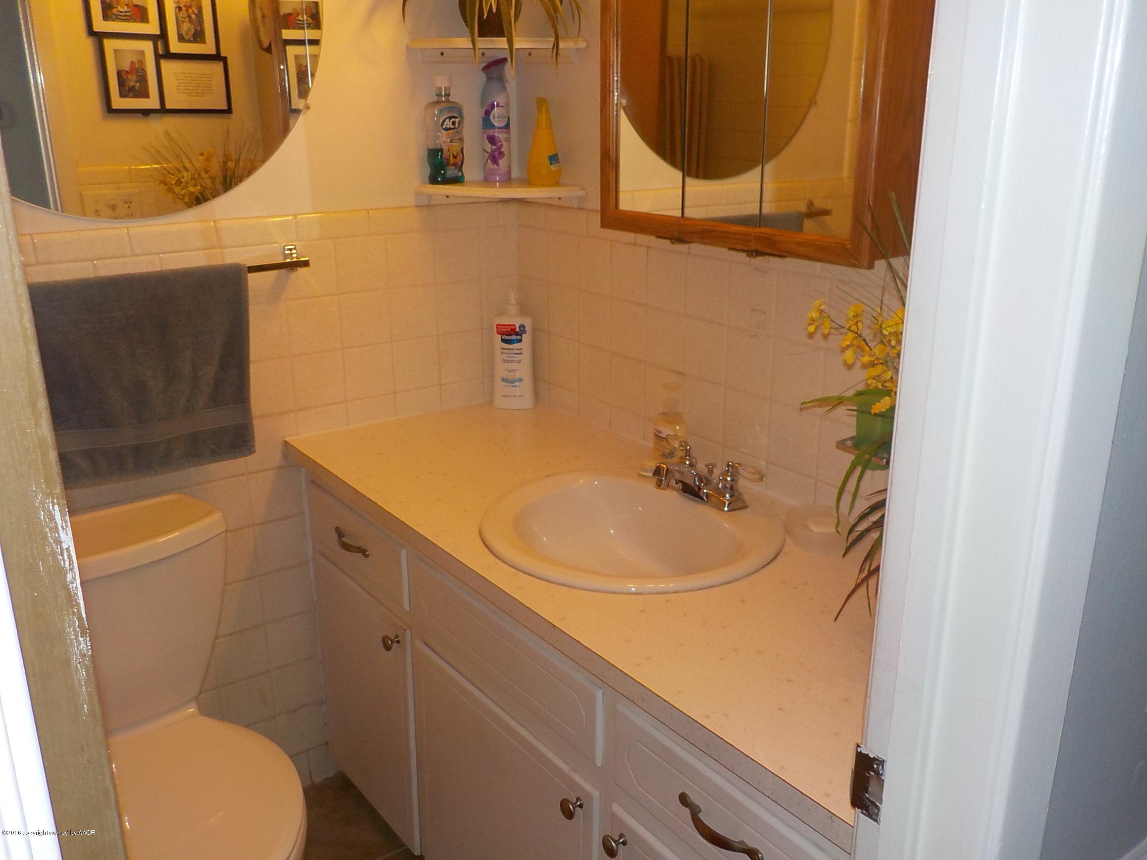 5102 Shield Drive Amarillo, TX 79110 - Photo 7 of 21 a bathroom with a sink and a mirror