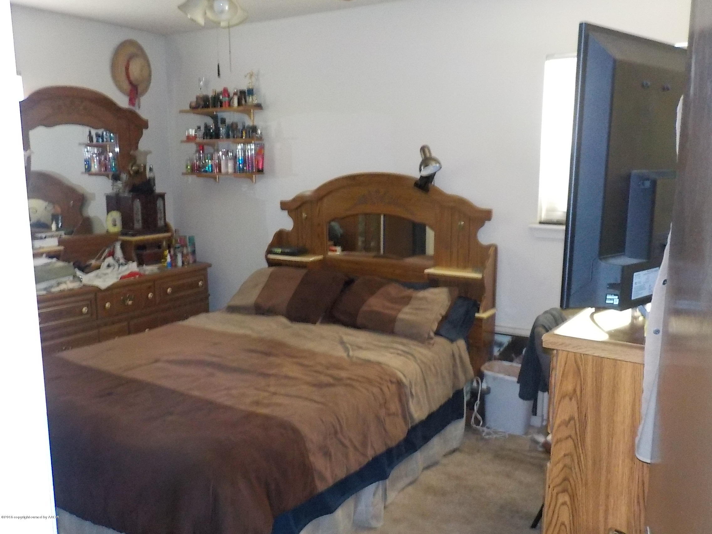 5102 Shield Drive Amarillo, TX 79110 - Photo 9 of 21 a bedroom with a bed and a dresser