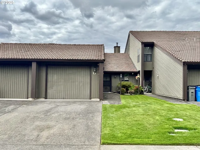 a view of a house with a yard and sitting area