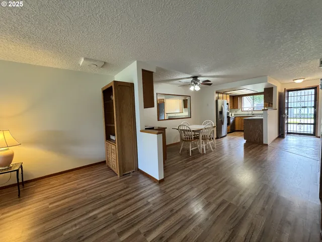 a view of a kitchen with furniture and wooden floor