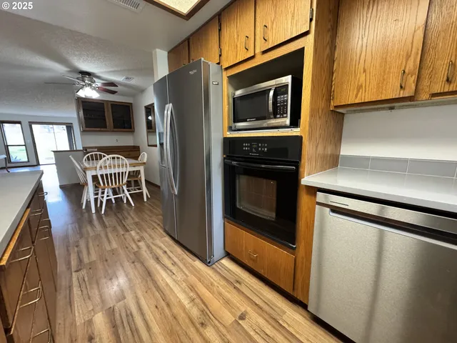 a kitchen with stainless steel appliances granite countertop a stove microwave and refrigerator