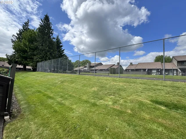 a view of yard with swimming pool and green space