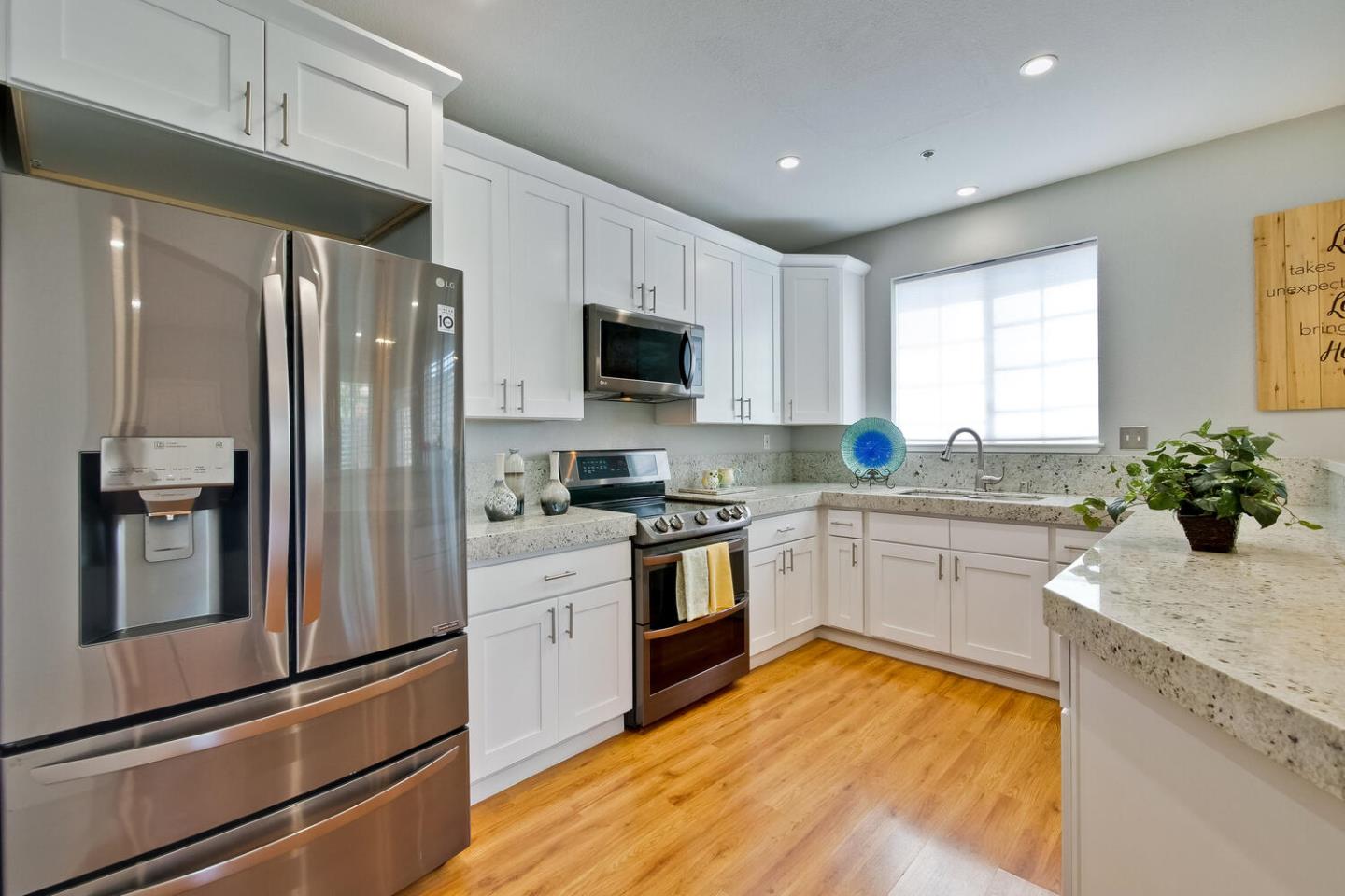 935 Old County Road, Unit 44 Belmont, CA 94002 - Photo 18 of 57 a kitchen with granite countertop stainless steel appliances and wooden cabinets