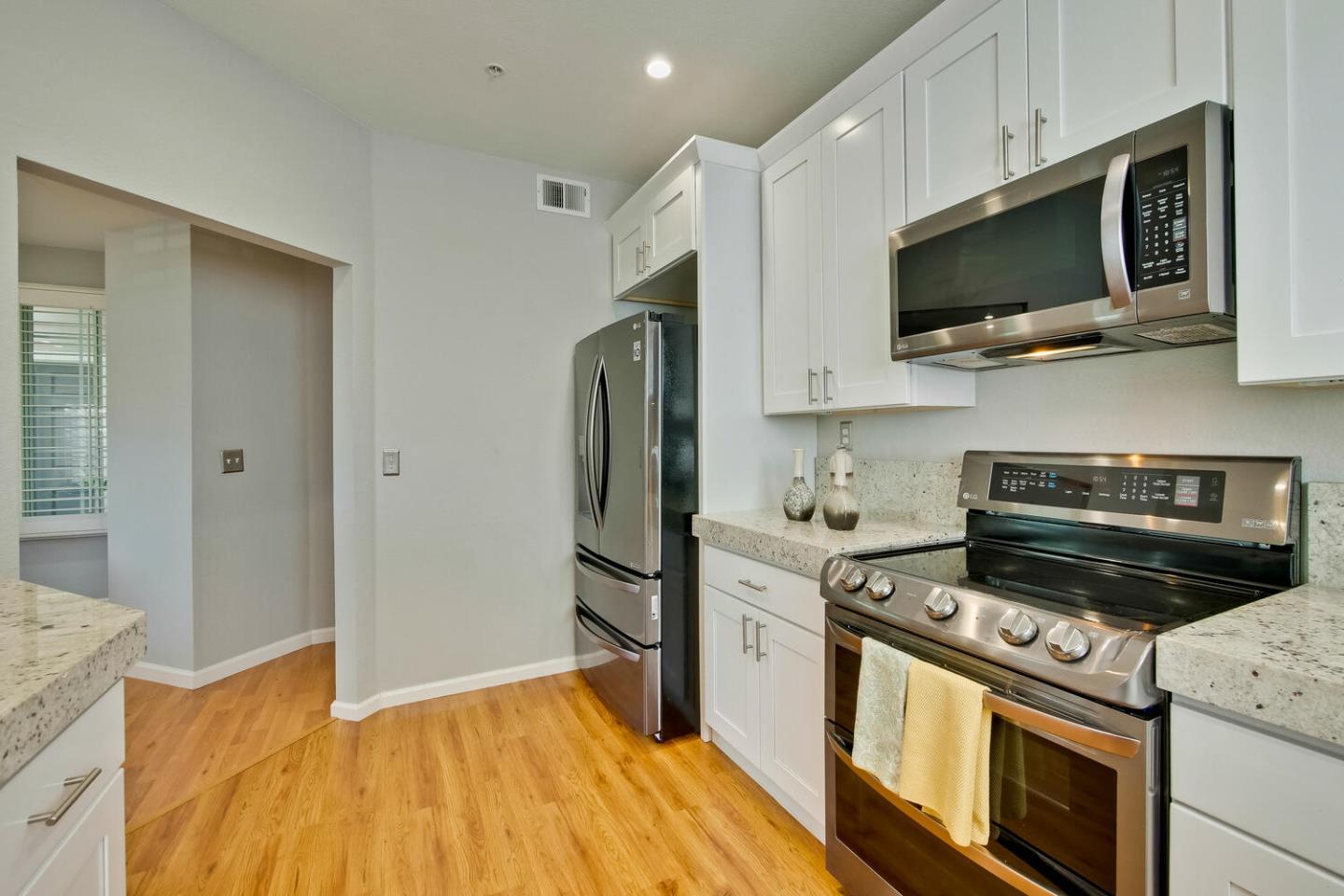 935 Old County Road, Unit 44 Belmont, CA 94002 - Photo 20 of 57 a kitchen with stainless steel appliances a stove a microwave and cabinets