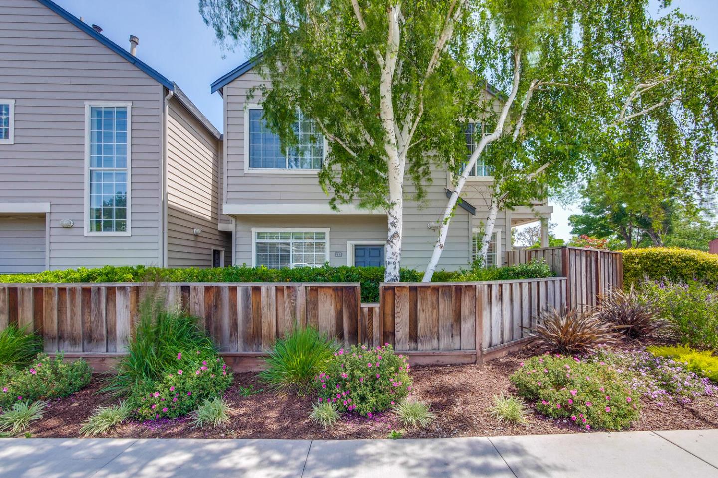 935 Old County Road, Unit 44 Belmont, CA 94002 - Photo 2 of 57 a front view of a house with garden and plants