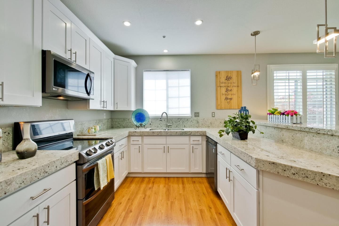 935 Old County Road, Unit 44 Belmont, CA 94002 - Photo 23 of 57 a kitchen with granite countertop a sink stainless steel appliances white cabinets and a window
