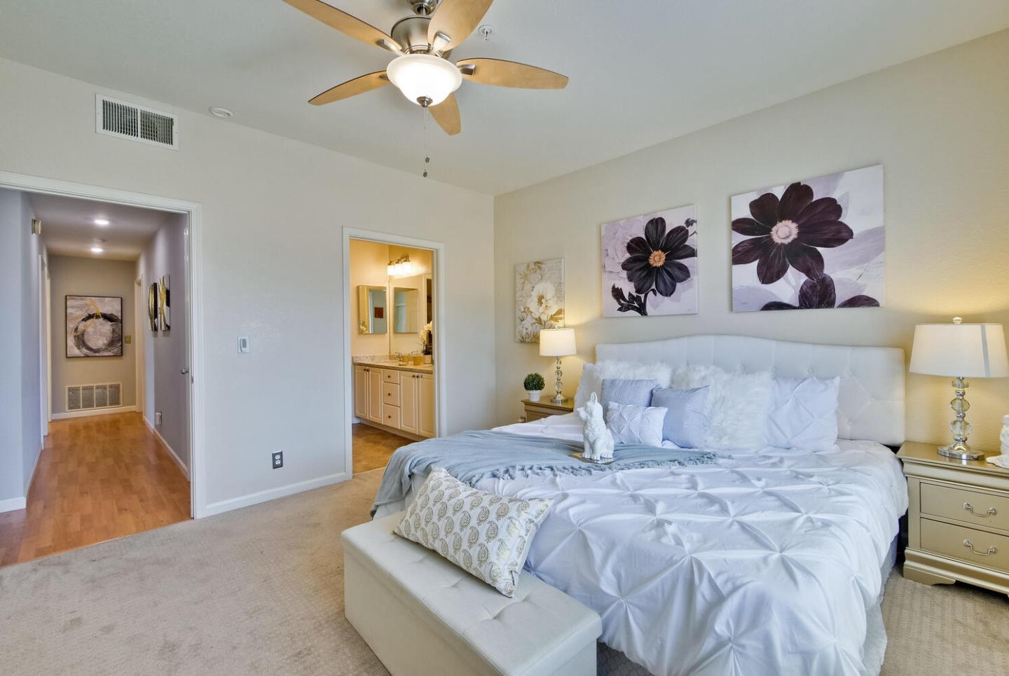 935 Old County Road, Unit 44 Belmont, CA 94002 - Photo 26 of 57 a bedroom with a large bed and a chandelier