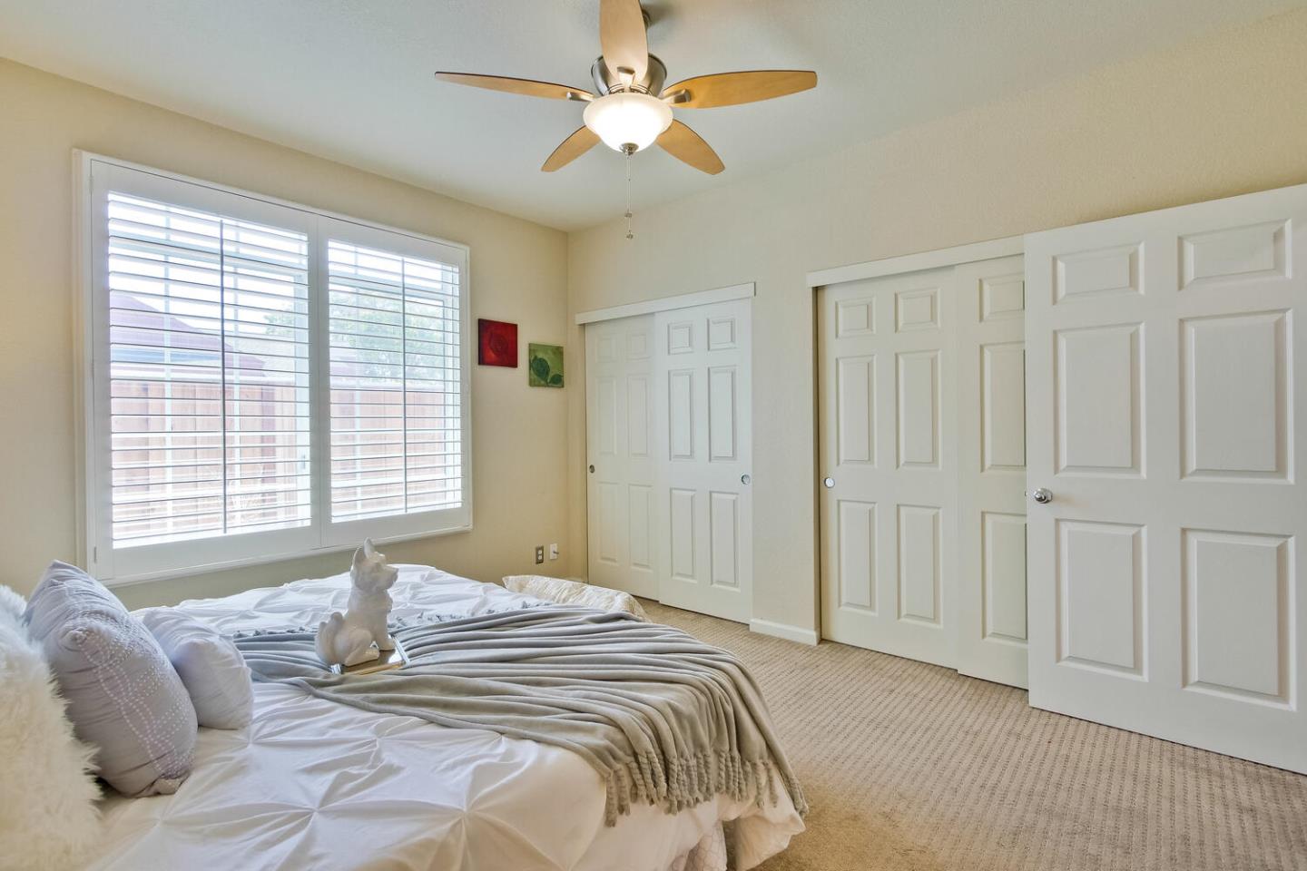 935 Old County Road, Unit 44 Belmont, CA 94002 - Photo 28 of 57 a bedroom with a large bed and a chandelier fan