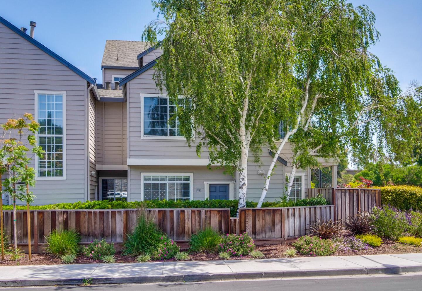 935 Old County Road, Unit 44 Belmont, CA 94002 - Photo 3 of 57 a front view of a house with yard and green space