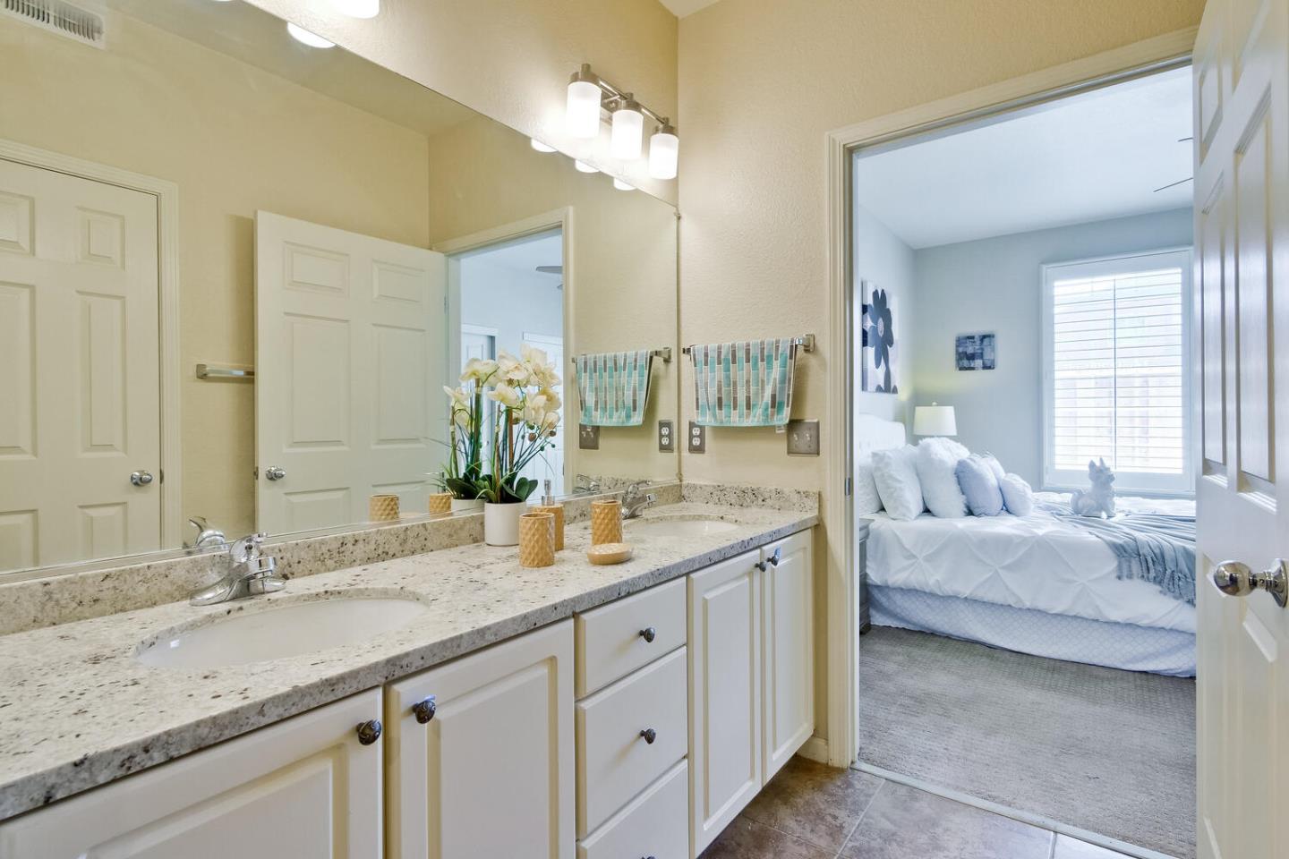 935 Old County Road, Unit 44 Belmont, CA 94002 - Photo 32 of 57 a bathroom with a granite countertop sink and a mirror