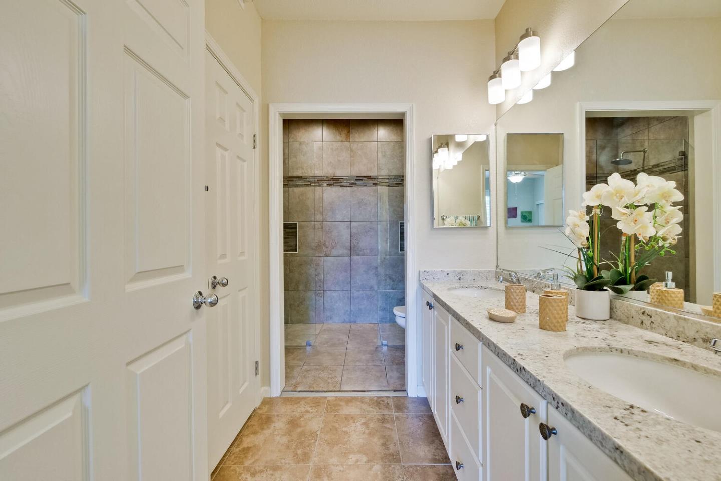 935 Old County Road, Unit 44 Belmont, CA 94002 - Photo 33 of 57 a bathroom with a granite countertop double vanity sink mirror and shower
