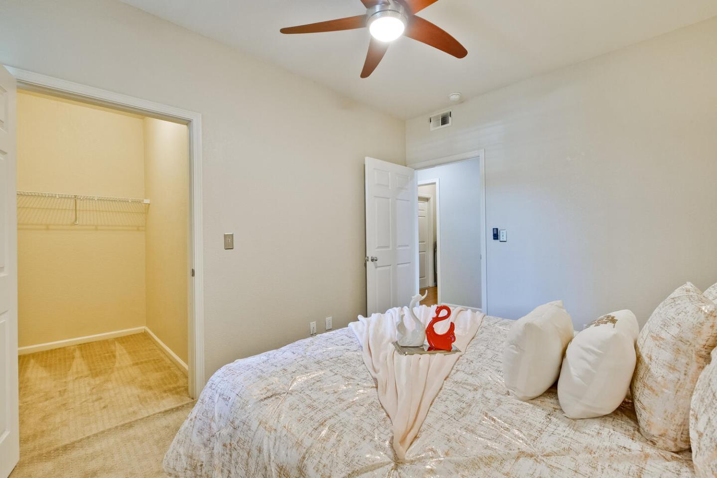 935 Old County Road, Unit 44 Belmont, CA 94002 - Photo 38 of 57 a bedroom with a bed and a chandelier