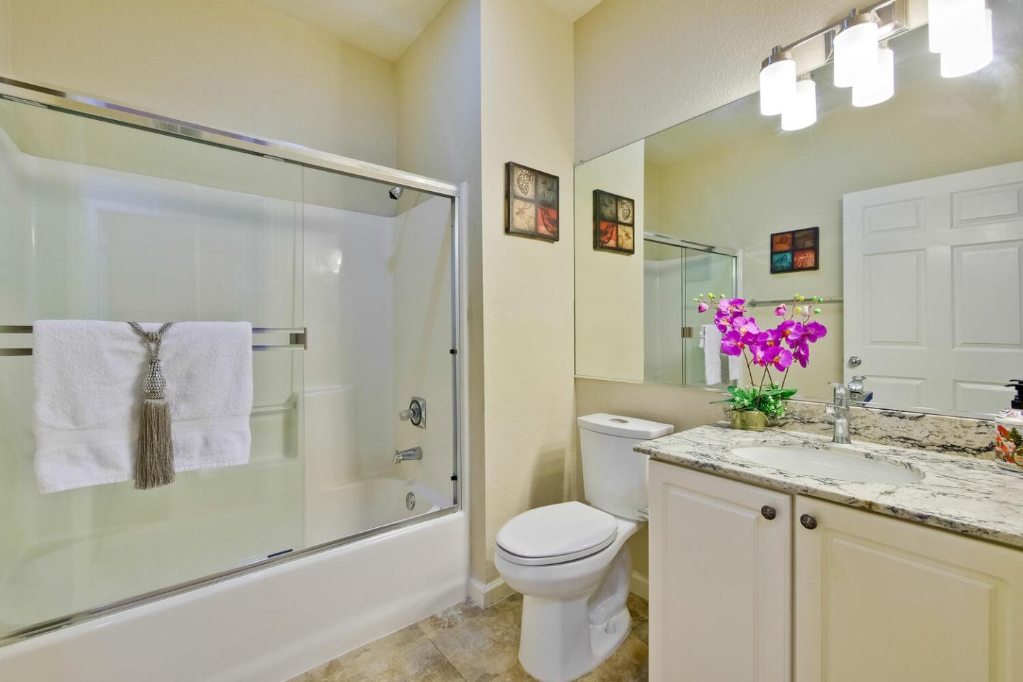 935 Old County Road, Unit 44 Belmont, CA 94002 - Photo 42 of 57 a bathroom with a granite countertop sink a toilet and shower