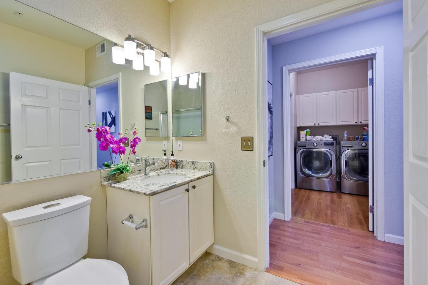935 Old County Road, Unit 44 Belmont, CA 94002 - Photo 43 of 57 a bathroom with a sink vanity mirror and toilet