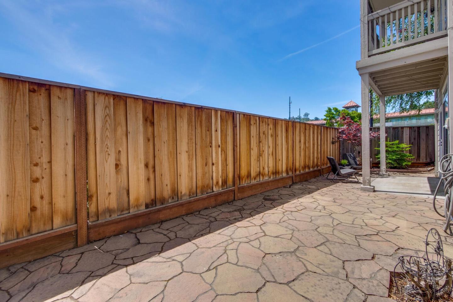 935 Old County Road, Unit 44 Belmont, CA 94002 - Photo 51 of 57 a view of a backyard with potted plants and wooden fence