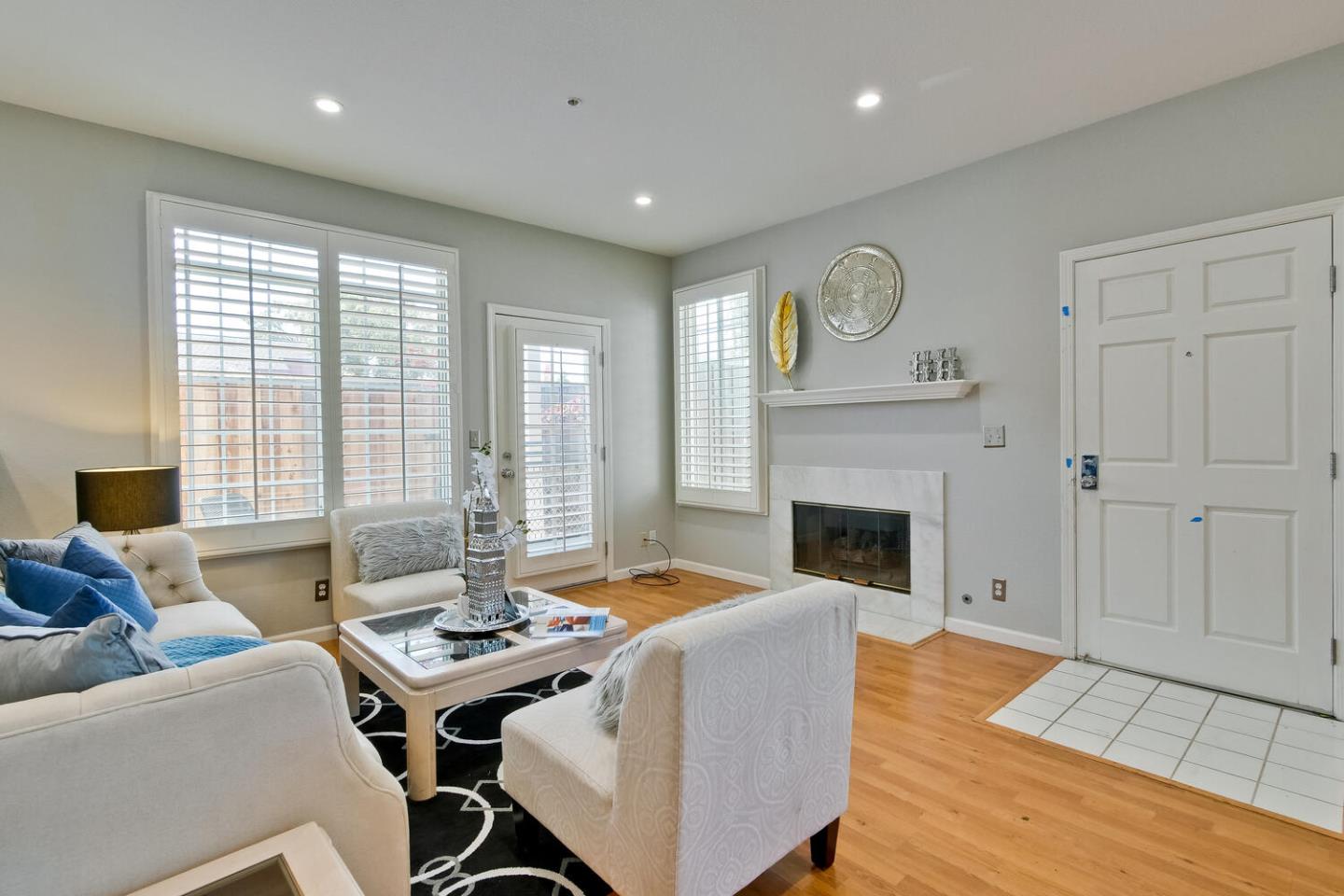 935 Old County Road, Unit 44 Belmont, CA 94002 - Photo 10 of 57 a living room with furniture a fireplace and a table