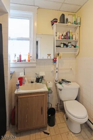 a bathroom with a sink a toilet and a window