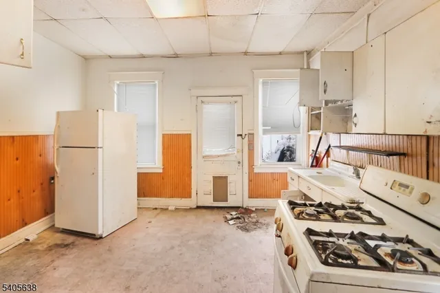 a kitchen with a refrigerator and white stove
