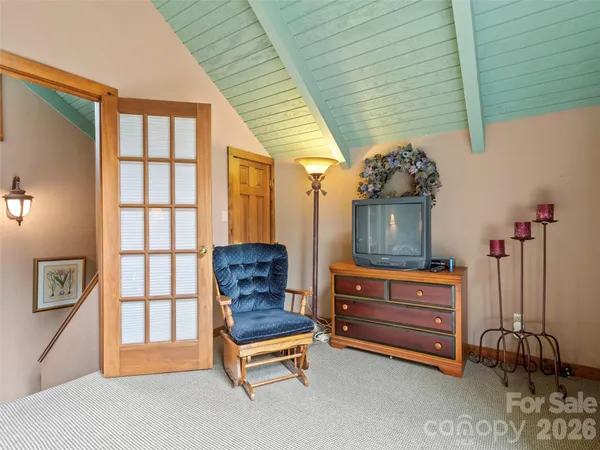 a living room with furniture a flat screen tv and a window