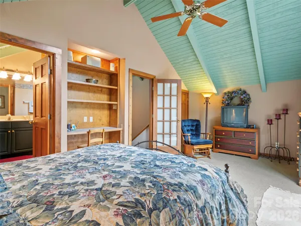 a bedroom with a bed and a chandelier