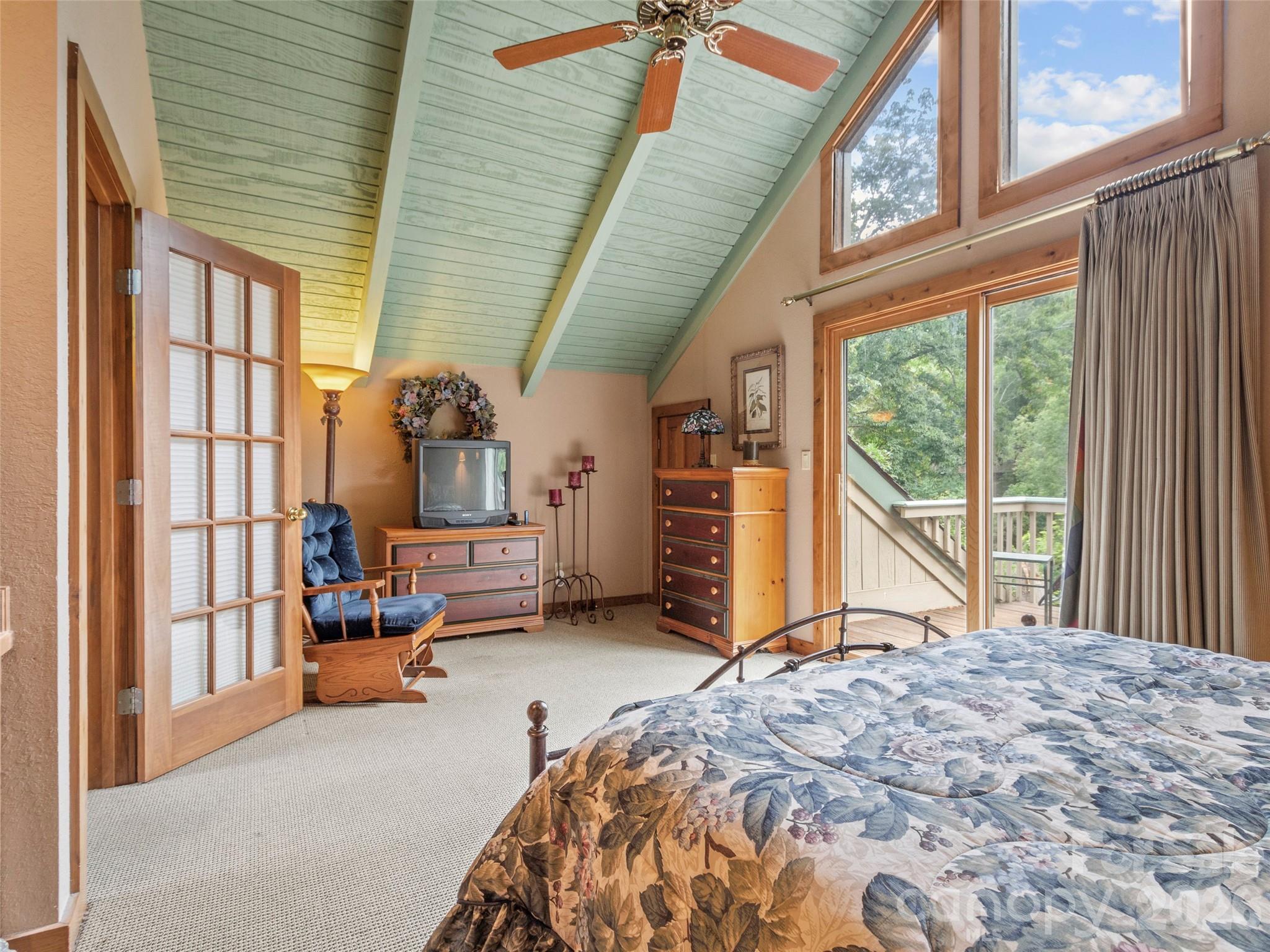 21 Ivy Ridge Road Burnsville, NC 28714 - Photo 32 of 35 a bedroom with a bed and large windows