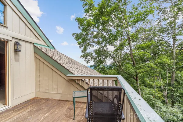 a roof deck with table and chairs