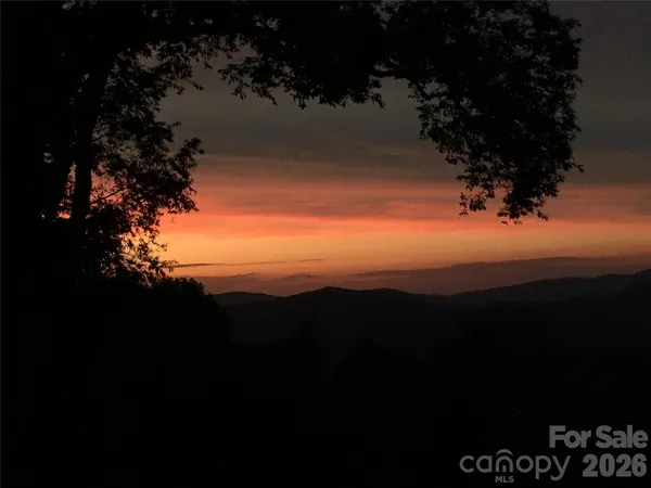 a view of sunset and a yard