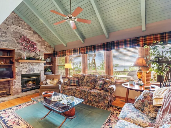 a living room with furniture fireplace and a large window