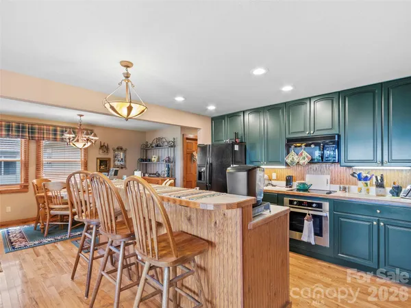 a kitchen with stainless steel appliances kitchen island granite countertop a sink and cabinets